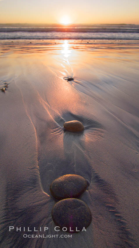 Cobblestone lies on the sand at the ocean's edge, sunset., natural history stock photograph, photo id 21776
