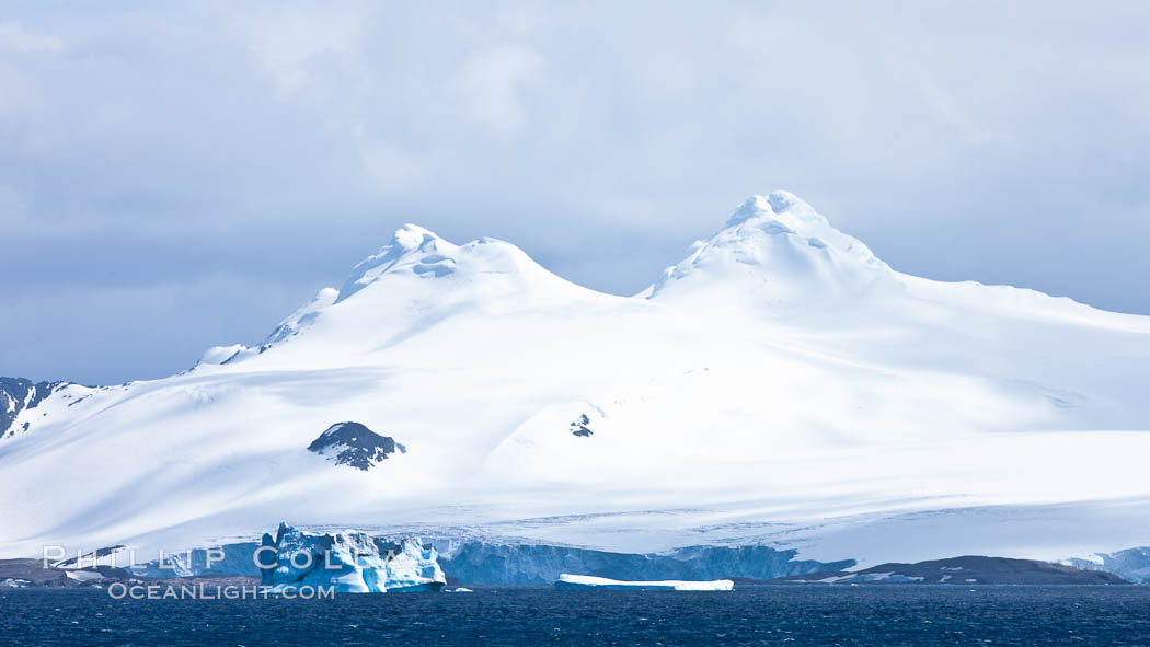 Coronation Island, is the largest of the South Orkney Islands, reaching 4,153' (1,266m) above sea level.  While it is largely covered by ice, Coronation Island also is home to some tundra habitat, and is inhabited by many seals, penguins and seabirds. Southern Ocean, natural history stock photograph, photo id 24940