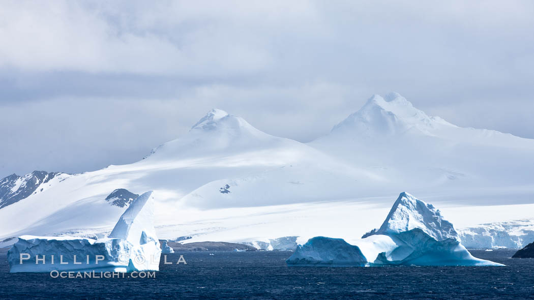 Coronation Island, is the largest of the South Orkney Islands, reaching 4,153' (1,266m) above sea level.  While it is largely covered by ice, Coronation Island also is home to some tundra habitat, and is inhabited by many seals, penguins and seabirds. Southern Ocean, natural history stock photograph, photo id 24851