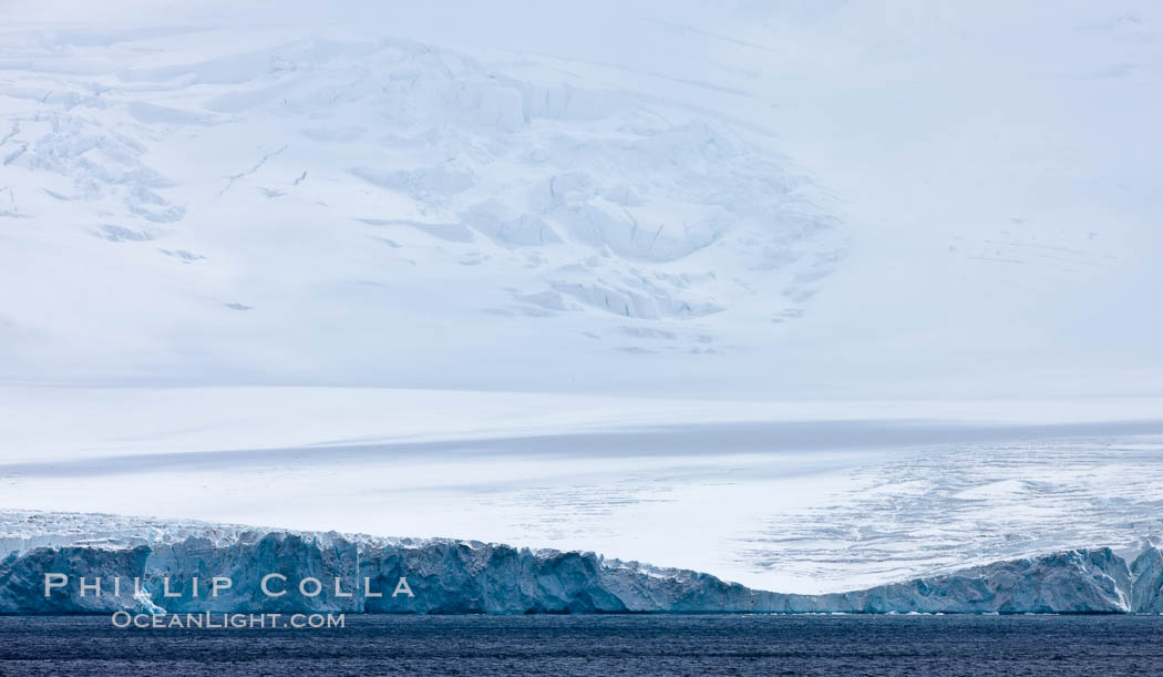 Coronation Island, is the largest of the South Orkney Islands, reaching 4,153' (1,266m) above sea level.  While it is largely covered by ice, Coronation Island also is home to some tundra habitat, and is inhabited by many seals, penguins and seabirds. Southern Ocean, natural history stock photograph, photo id 24941