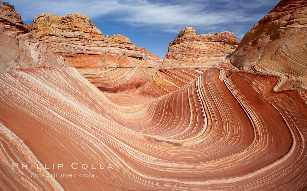 The Wave, an area of fantastic eroded sandstone featuring beautiful swirls, wild colors, countless striations, and bizarre shapes set amidst the dramatic surrounding North Coyote Buttes of Arizona and Utah.  The sandstone formations of the North Coyote Buttes, including the Wave, date from the Jurassic period. Managed by the Bureau of Land Management, the Wave is located in the Paria Canyon-Vermilion Cliffs Wilderness and is accessible on foot by permit only. USA, natural history stock photograph, photo id 20696