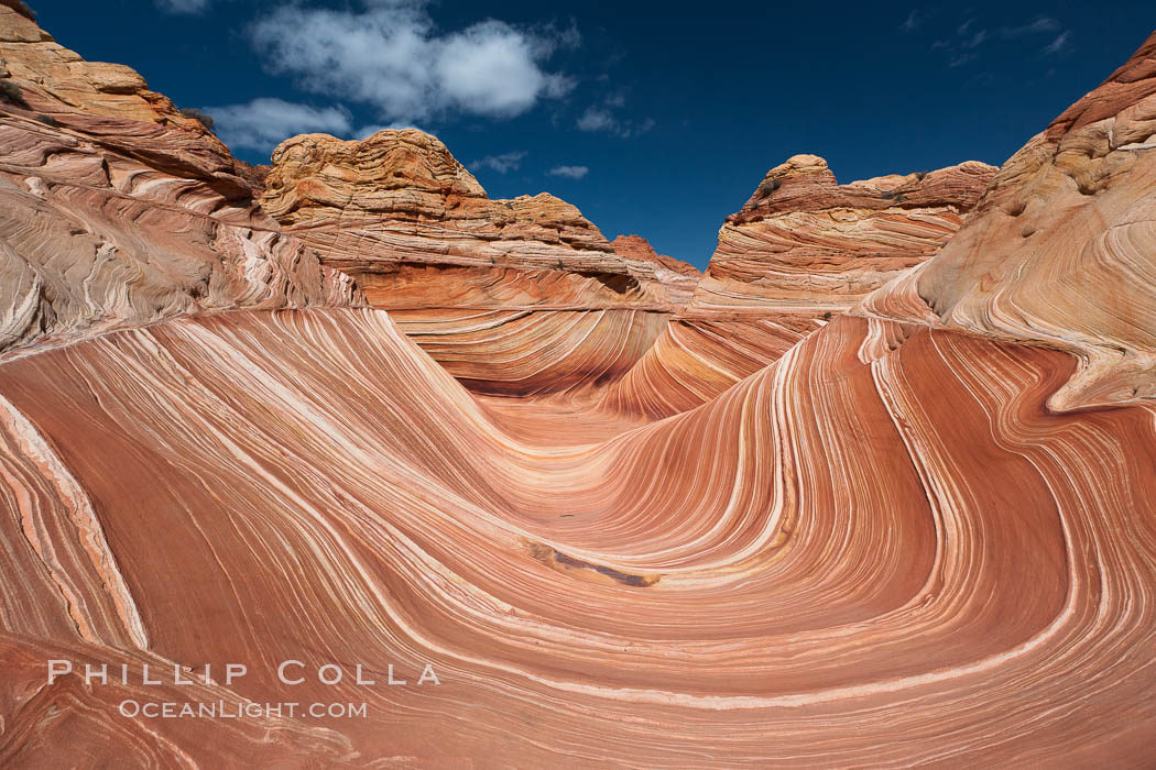 The Wave, an area of fantastic eroded sandstone featuring beautiful swirls, wild colors, countless striations, and bizarre shapes set amidst the dramatic surrounding North Coyote Buttes of Arizona and Utah.  The sandstone formations of the North Coyote Buttes, including the Wave, date from the Jurassic period. Managed by the Bureau of Land Management, the Wave is located in the Paria Canyon-Vermilion Cliffs Wilderness and is accessible on foot by permit only. USA, natural history stock photograph, photo id 20691