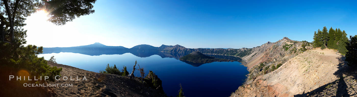 Panorama of Crater Lake at sunrise.  Crater Lake is the six-mile wide lake inside the collapsed caldera of volcanic Mount Mazama. Crater Lake is the deepest lake in the United States and the seventh-deepest in the world. Its maximum recorded depth is 1996 feet (608m). It lies at an altitude of 6178 feet (1880m). Crater Lake National Park, Oregon, USA, natural history stock photograph, photo id 19114