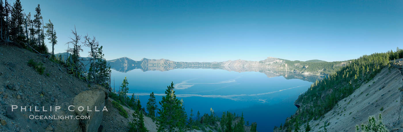 Panorama of Crater Lake, early morning. Crater Lake is the six-mile wide lake inside the collapsed caldera of volcanic Mount Mazama. Crater Lake is the deepest lake in the United States and the seventh-deepest in the world. Its maximum recorded depth is 1996 feet (608m). It lies at an altitude of 6178 feet (1880m). Crater Lake National Park, Oregon, USA, natural history stock photograph, photo id 19116