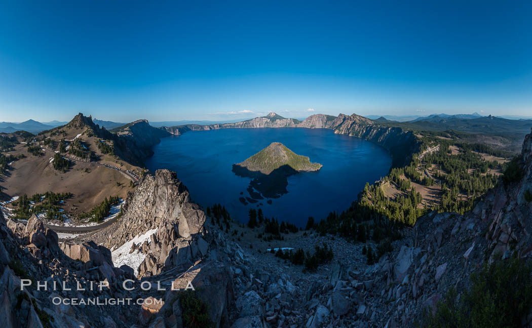 Panorama of Crater Lake from Watchman Lookout Station, panoramic picture. The Watchman Lookout Station No. 168 is one of two fire lookout towers in Crater Lake National Park in southern Oregon. For many years, National Park Service personnel used the lookout to watch for wildfires during the summer months. It is also a popular hiking destination because it offers an excellent view of Crater Lake and the surrounding area. USA, natural history stock photograph, photo id 28634