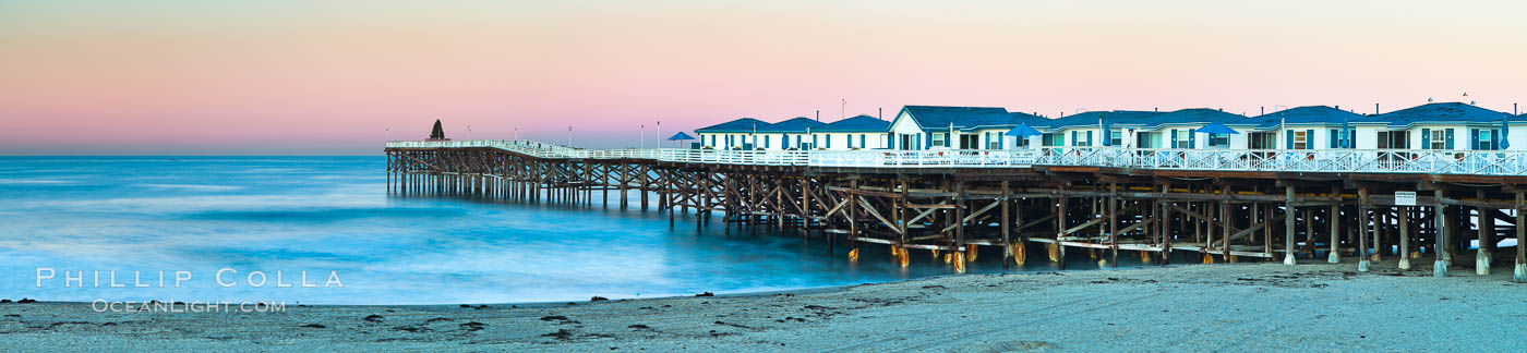 The Crystal Pier and Pacific Ocean at sunrise, dawn, waves blur as they crash upon the sand.  Crystal Pier, 872 feet long and built in 1925, extends out into the Pacific Ocean from the town of Pacific Beach. California, USA, natural history stock photograph, photo id 27246