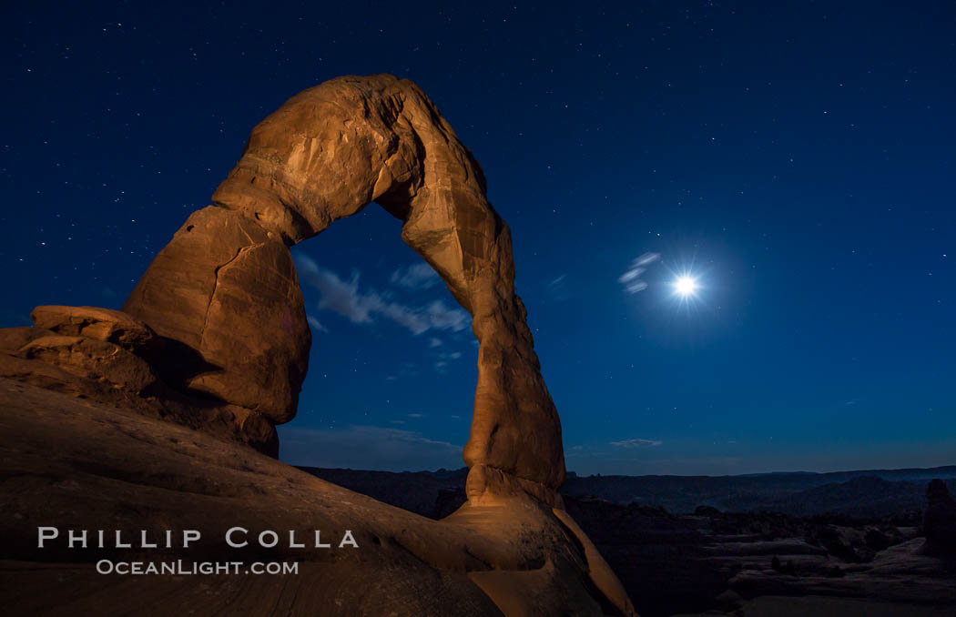 Delicate Arch and the Moon at Sunset.  The moon and clouds, with stars showing faintly in the sky, as sunset fades into night. Arches National Park, Utah, USA, natural history stock photograph, photo id 27861