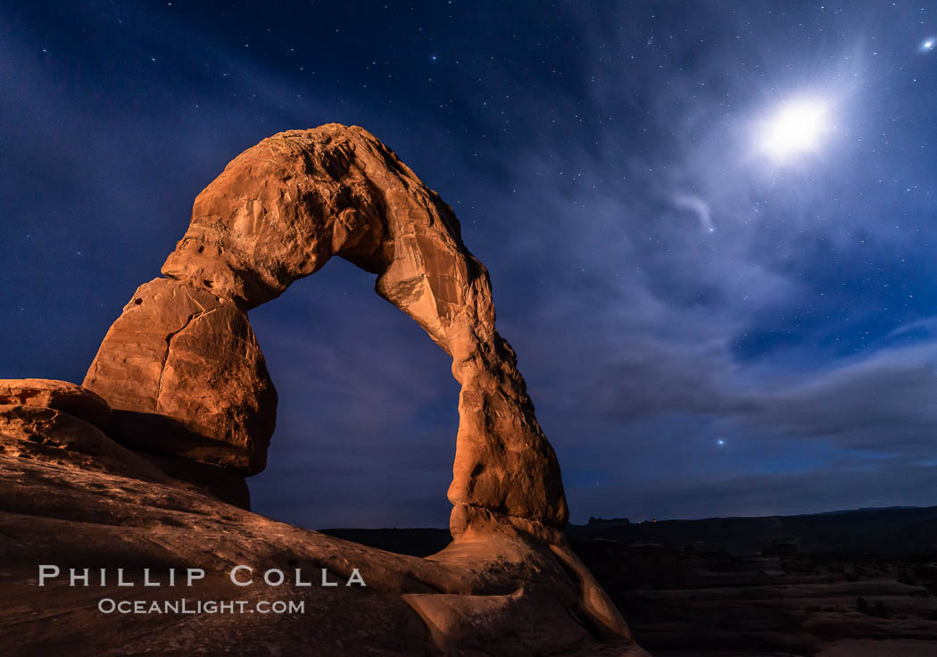 Delicate Arch with Stars and Moon, at night, Arches National Park (Note: this image was created before a ban on light-painting in Arches National Park was put into effect.  Light-painting is no longer permitted in Arches National Park). Utah, USA, natural history stock photograph, photo id 29284