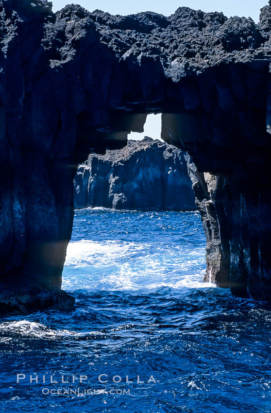 Arcos del Diablo (Devils Arches), a series of enormous volcanic arches that were originally lava tubes.  Some of the arches are exposed above water (seen here) while at least one that we discovered is entirely submarine (El Secreto del Vicki).  Weather side of Guadalupe Island (Isla Guadalupe). Baja California, Mexico, natural history stock photograph, photo id 09764