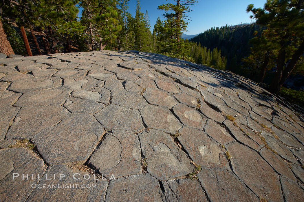 Devil's Postpile, a spectacular example of columnar basalt.  Once molten and under great pressure underground, the lava that makes up Devil's Postpile cooled evenly and slowly, contracting and fracturing into polygonal-sided columns.  The age of the formation is estimated between 100 and 700 thousand years old.  Sometime after the basalt columns formed, a glacier passed over the formation, cutting and polishing the tops of the columns.  The columns have from three to seven sides, varying because of differences in how quickly portions of the lava cooled. Devils Postpile National Monument, California, USA, natural history stock photograph, photo id 23267