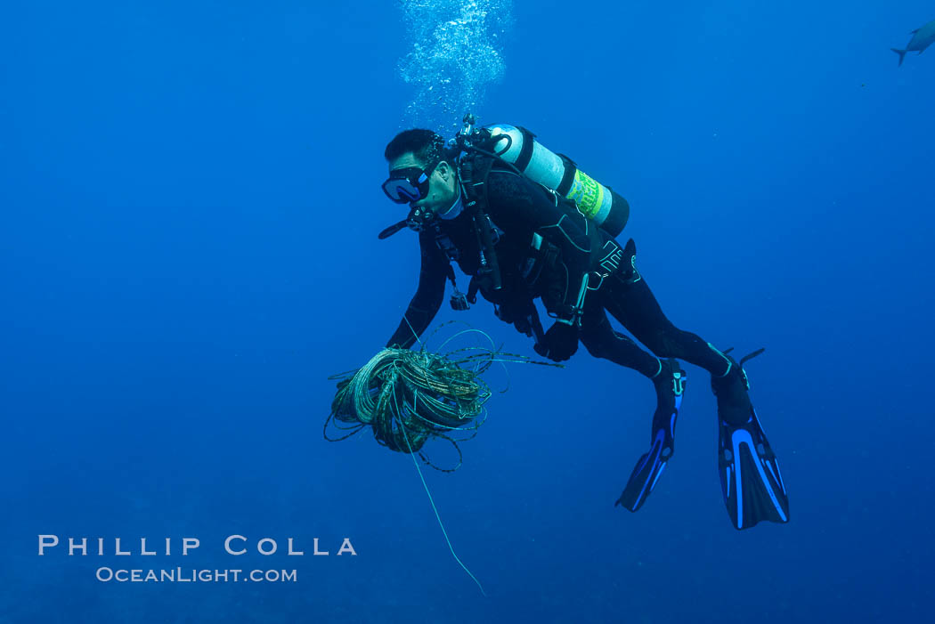 Diver collecting fishing line and debris from coral reef, Clipperton Island. France, natural history stock photograph, photo id 33055
