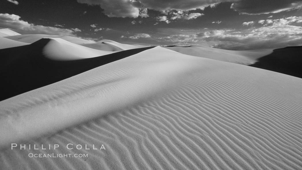 Eureka Sand Dunes, infrared black and white.  The Eureka Dunes are California's tallest sand dunes, and one of the tallest in the United States.  Rising 680' above the floor of the Eureka Valley, the Eureka sand dunes are home to several endangered species, as well as "singing sand" that makes strange sounds when it shifts. Death Valley National Park, USA, natural history stock photograph, photo id 25278