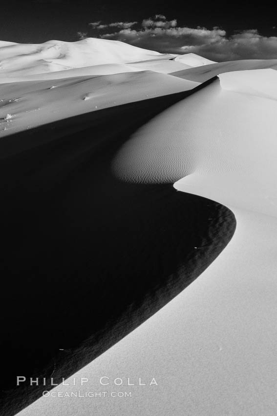Eureka Sand Dunes, infrared black and white.  The Eureka Dunes are California's tallest sand dunes, and one of the tallest in the United States.  Rising 680' above the floor of the Eureka Valley, the Eureka sand dunes are home to several endangered species, as well as "singing sand" that makes strange sounds when it shifts. Death Valley National Park, USA, natural history stock photograph, photo id 25376