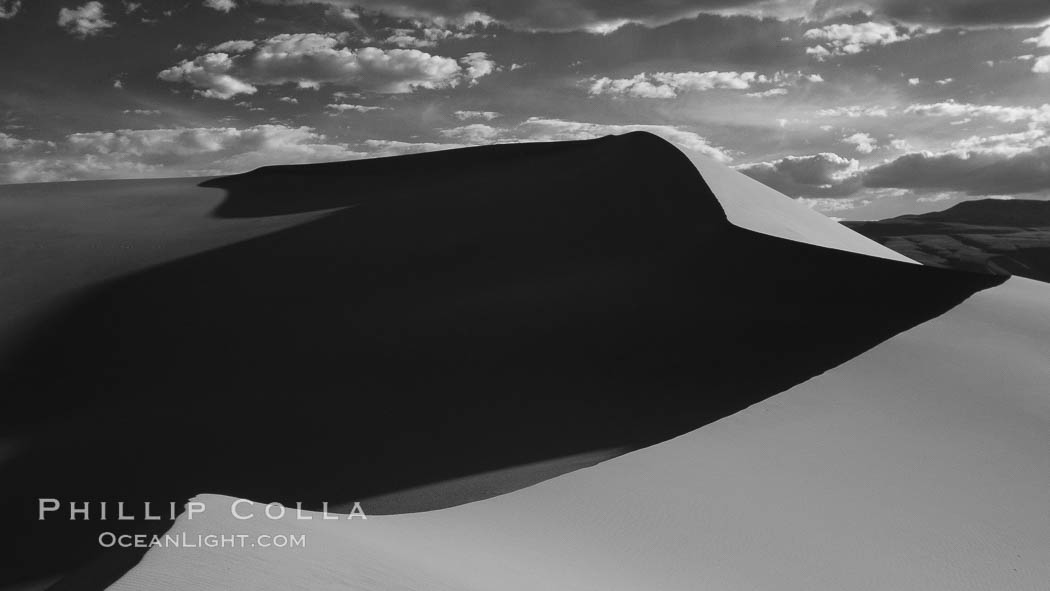 Eureka Sand Dunes, infrared black and white.  The Eureka Dunes are California's tallest sand dunes, and one of the tallest in the United States.  Rising 680' above the floor of the Eureka Valley, the Eureka sand dunes are home to several endangered species, as well as "singing sand" that makes strange sounds when it shifts. Death Valley National Park, USA, natural history stock photograph, photo id 25379