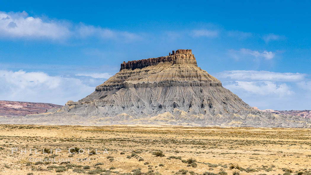 Factory Butte. An exceptional example of a solitary butte surrounded by dramatically eroded badlands, Factory Butte stands alone on the San Rafael Swell. Hanksville, Utah, USA, natural history stock photograph, photo id 37872