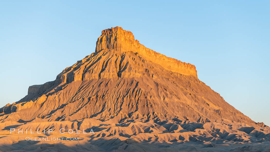 Factory Butte at sunrise. An exceptional example of solitary butte surrounded by dramatically eroded badlands, Factory Butte stands alone on the San Rafael Swell. Hanksville, Utah, USA, natural history stock photograph, photo id 37019