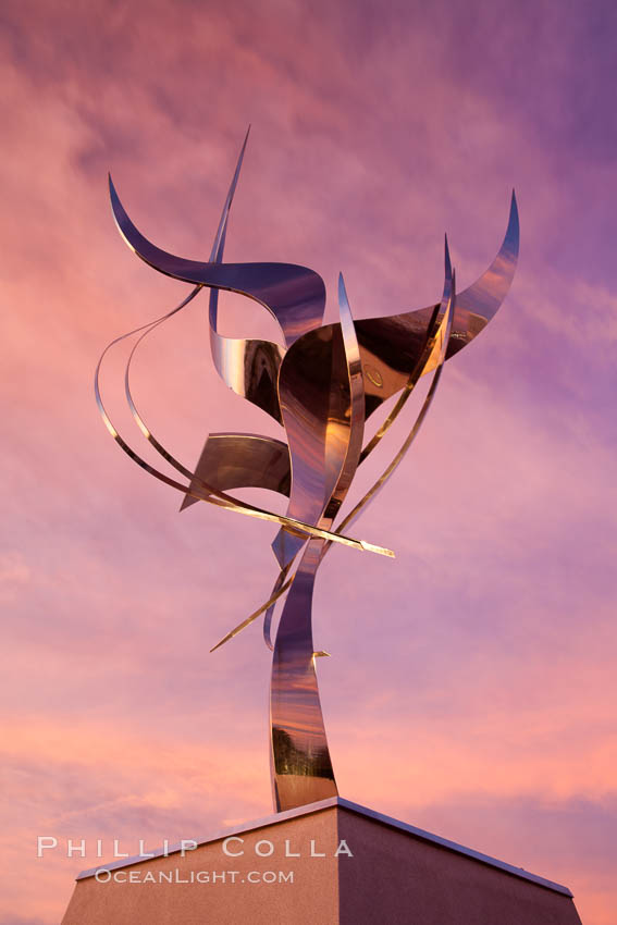 Flama de la Amistad, a statue by Leonardo Nierman.  Installed in the San Diego Convention Centers outdoor amphitheater, Flame of Friendship is a polished, stainless-steel statue set against San Diego Bay weighing 3,700 pounds and standing 20 feet tall and eight feet wide. California, USA, natural history stock photograph, photo id 26554