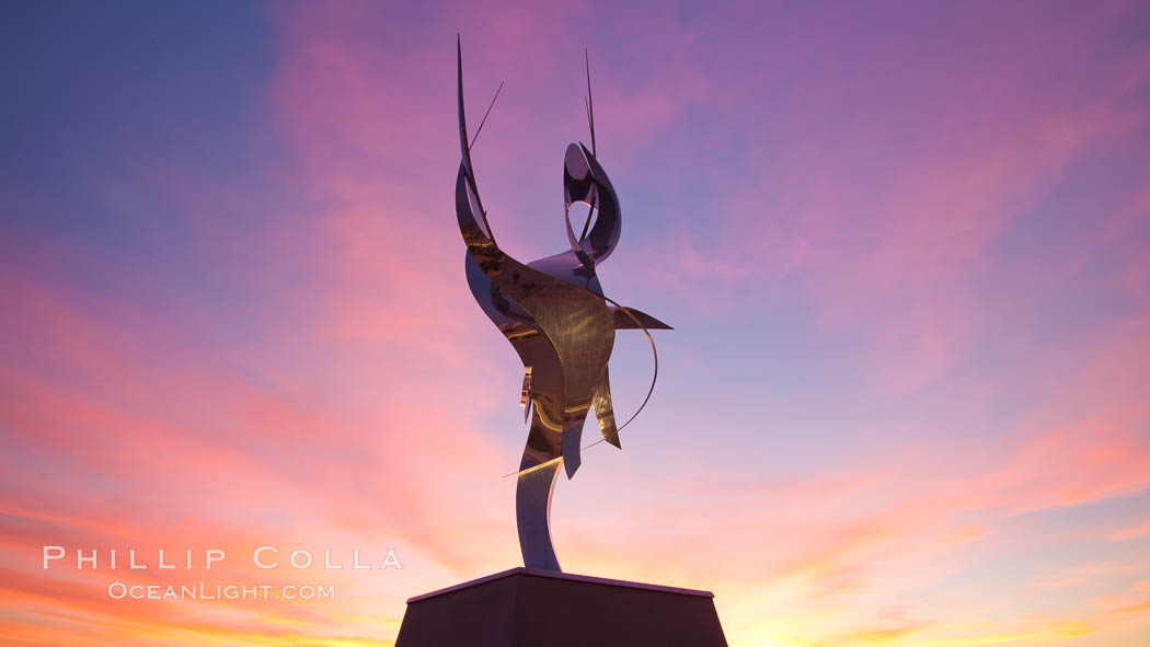 Flama de la Amistad, a statue by Leonardo Nierman.  Installed in the San Diego Convention Centers outdoor amphitheater, Flame of Friendship is a polished, stainless-steel statue set against San Diego Bay weighing 3,700 pounds and standing 20 feet tall and eight feet wide. California, USA, natural history stock photograph, photo id 26557