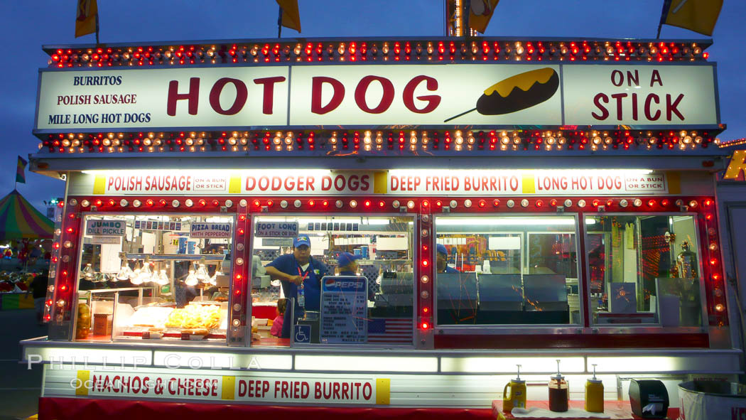 Food vendors at the Del Mar Fair, famous for their tasty, greasy, salty, fattening and generally unwholesome food, which visitors eat by the ton.  Bright lights at night. California, USA, natural history stock photograph, photo id 20874