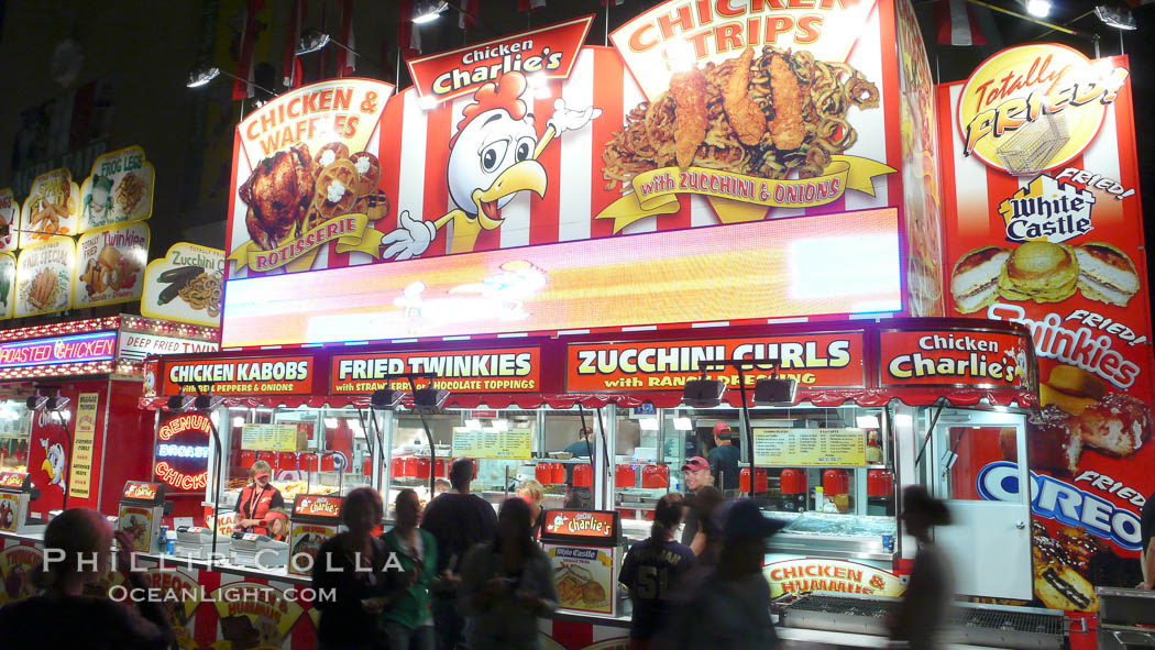 Food vendors at the Del Mar Fair, famous for their tasty, greasy, salty, fattening and generally unwholesome food, which visitors eat by the ton.  Bright lights at night. California, USA, natural history stock photograph, photo id 20882