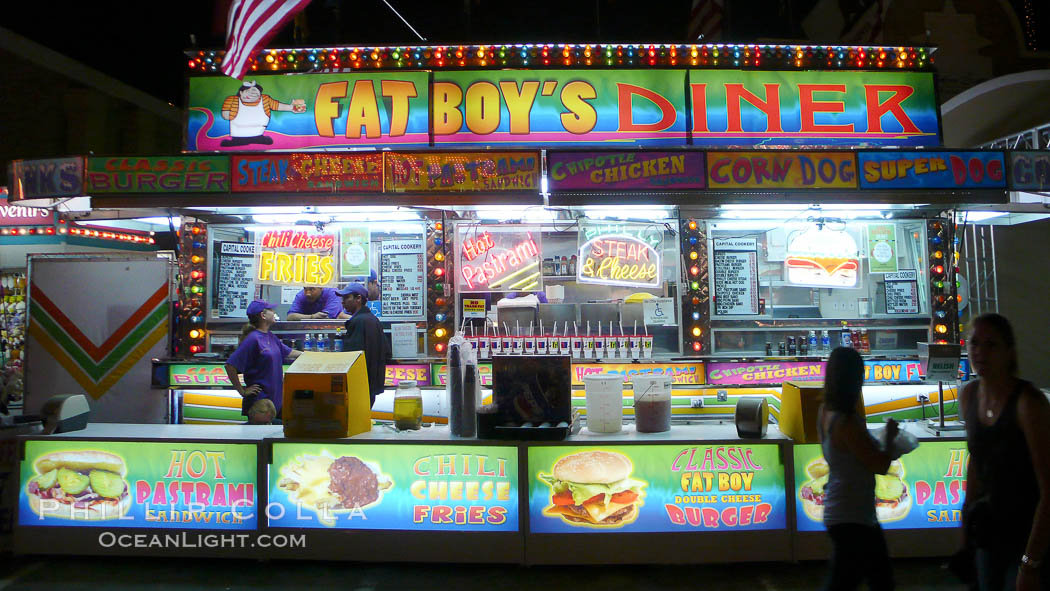 Food vendors at the Del Mar Fair, famous for their tasty, greasy, salty, fattening and generally unwholesome food, which visitors eat by the ton.  Bright lights at night. California, USA, natural history stock photograph, photo id 20879