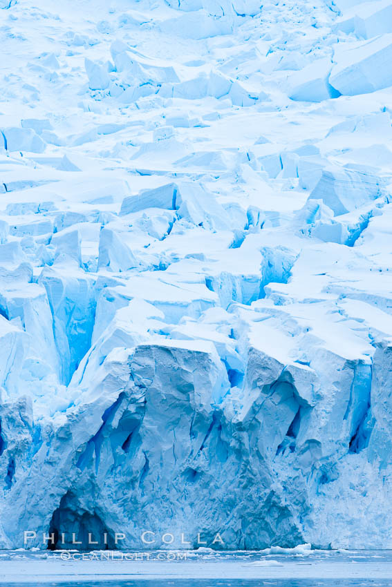 A glacier fractures and cracks, as the leading of a glacier fractures and cracks as it reaches the ocean.  The pieces will float away to become icebergs. Neko Harbor, Antarctic Peninsula, Antarctica, natural history stock photograph, photo id 25742