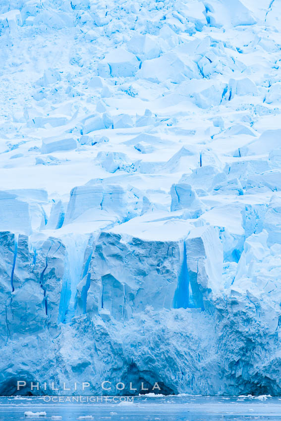 A glacier fractures and cracks, as the leading of a glacier fractures and cracks as it reaches the ocean.  The pieces will float away to become icebergs. Neko Harbor, Antarctic Peninsula, Antarctica, natural history stock photograph, photo id 25672