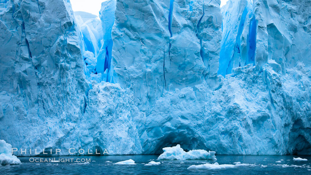 A glacier fractures and cracks, as the leading edge reaches the ocean.  The pieces will float away to become icebergs. Neko Harbor, Antarctic Peninsula, Antarctica, natural history stock photograph, photo id 25739