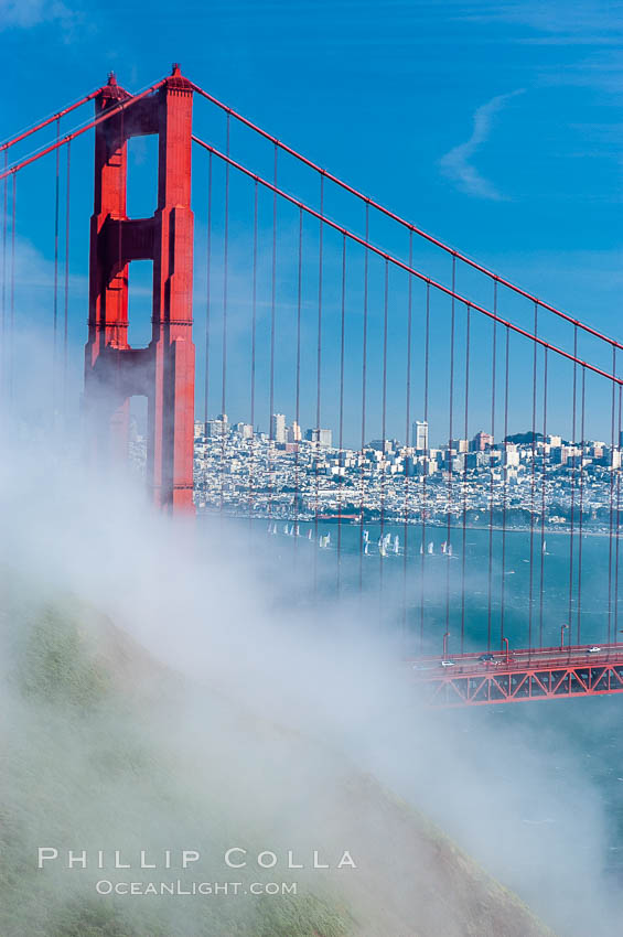 San Franciscos infamous summer fog overtakes the Golden Gate Bridge, viewed from the Marin Headlands with the city of San Francisco visible in the distance. California, USA, natural history stock photograph, photo id 09063