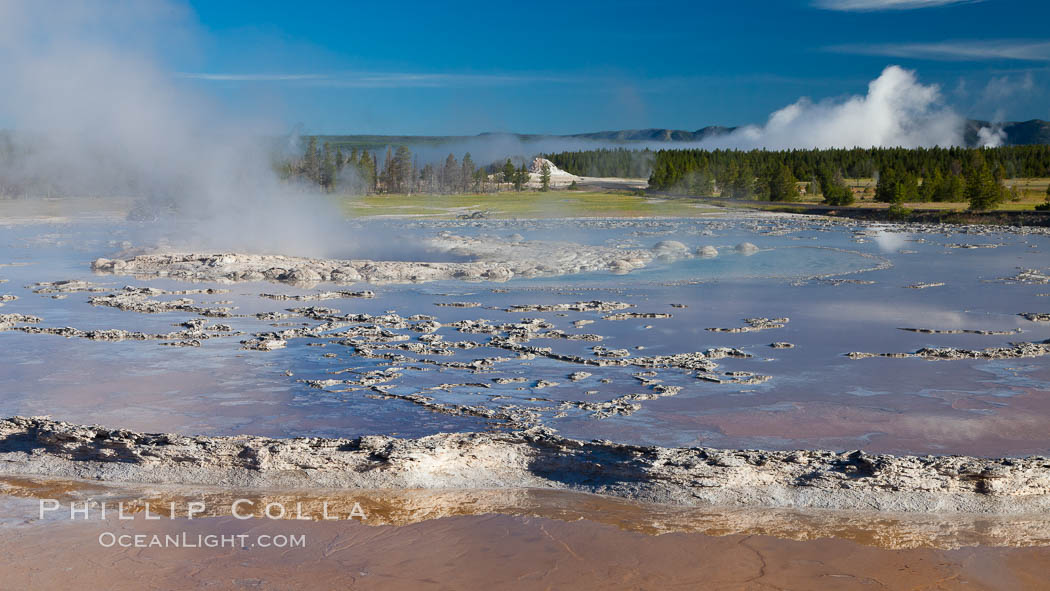 Great Fountain geyser.  Great Fountain geyser's large vent (16 feet across) sits amid wide sinter terraces that act as reflecting pools as the geyser slows fills prior to its eruption. Lower Geyser Basin, Yellowstone National Park, Wyoming, USA, natural history stock photograph, photo id 26948