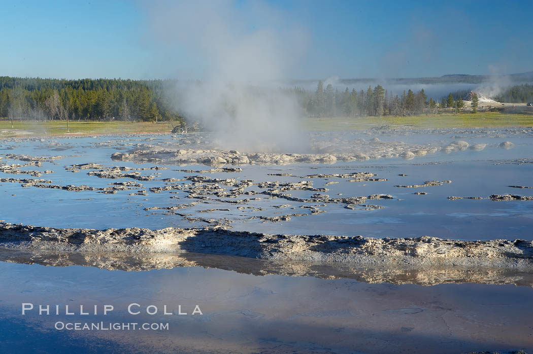 Great Fountains large vent (16 feet across) sits amid wide sinter terraces that act as reflecting pools as the geyser slows fills prior to its eruption.  Firehole Lake Drive. Lower Geyser Basin, Yellowstone National Park, Wyoming, USA, natural history stock photograph, photo id 13562