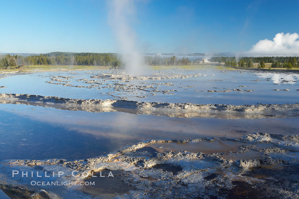 Great Fountains large vent (16 feet across) sits amid wide sinter terraces that act as reflecting pools as the geyser slows fills prior to its eruption.  Firehole Lake Drive. Lower Geyser Basin, Yellowstone National Park, Wyoming, USA, natural history stock photograph, photo id 13561