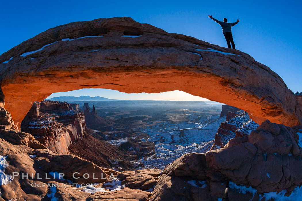 Extended High Mountain pose, Utthita Tadasana, sunrise on Mesa Arch, Utah.  An exuberant hiker greets the dawning sun from atop Mesa Arch. Island in the Sky, Canyonlands National Park, USA, natural history stock photograph, photo id 18036