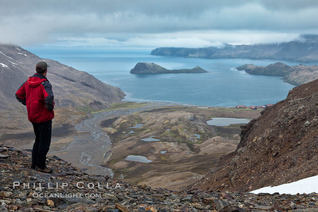 Hiker looks down on Stromness Harbour from the pass high above. South Georgia Island, natural history stock photograph, photo id 24582
