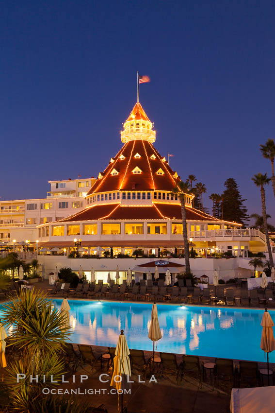 Hotel del Coronado with holiday Christmas night lights, known affectionately as the Hotel Del. It was once the largest hotel in the world, and is one of the few remaining wooden Victorian beach resorts. It sits on the beach on Coronado Island, seen here with downtown San Diego in the distance. It is widely considered to be one of Americas most beautiful and classic hotels. Built in 1888, it was designated a National Historic Landmark in 1977. California, USA, natural history stock photograph, photo id 27398