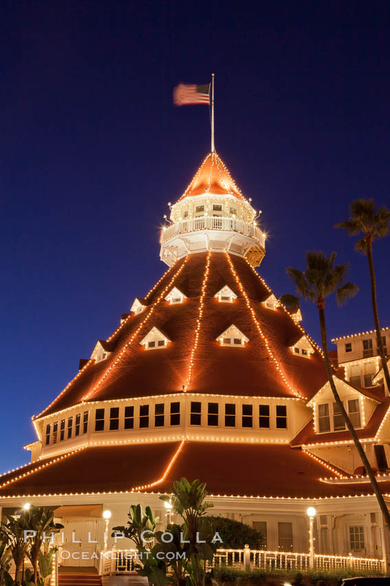 Hotel del Coronado with holiday Christmas night lights, known affectionately as the Hotel Del. It was once the largest hotel in the world, and is one of the few remaining wooden Victorian beach resorts. It sits on the beach on Coronado Island, seen here with downtown San Diego in the distance. It is widely considered to be one of Americas most beautiful and classic hotels. Built in 1888, it was designated a National Historic Landmark in 1977. California, USA, natural history stock photograph, photo id 27402