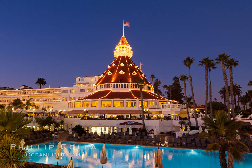 Hotel del Coronado with holiday Christmas night lights, known affectionately as the Hotel Del. It was once the largest hotel in the world, and is one of the few remaining wooden Victorian beach resorts. It sits on the beach on Coronado Island, seen here with downtown San Diego in the distance. It is widely considered to be one of Americas most beautiful and classic hotels. Built in 1888, it was designated a National Historic Landmark in 1977. California, USA, natural history stock photograph, photo id 27397