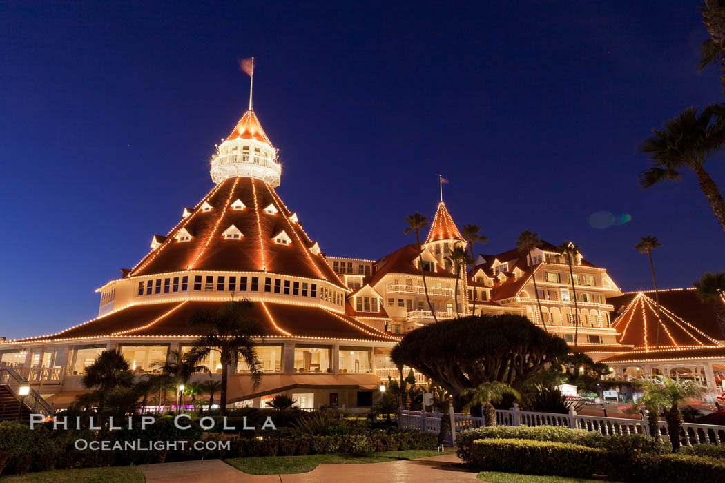 Hotel del Coronado with holiday Christmas night lights, known affectionately as the Hotel Del. It was once the largest hotel in the world, and is one of the few remaining wooden Victorian beach resorts. It sits on the beach on Coronado Island, seen here with downtown San Diego in the distance. It is widely considered to be one of Americas most beautiful and classic hotels. Built in 1888, it was designated a National Historic Landmark in 1977. California, USA, natural history stock photograph, photo id 27401