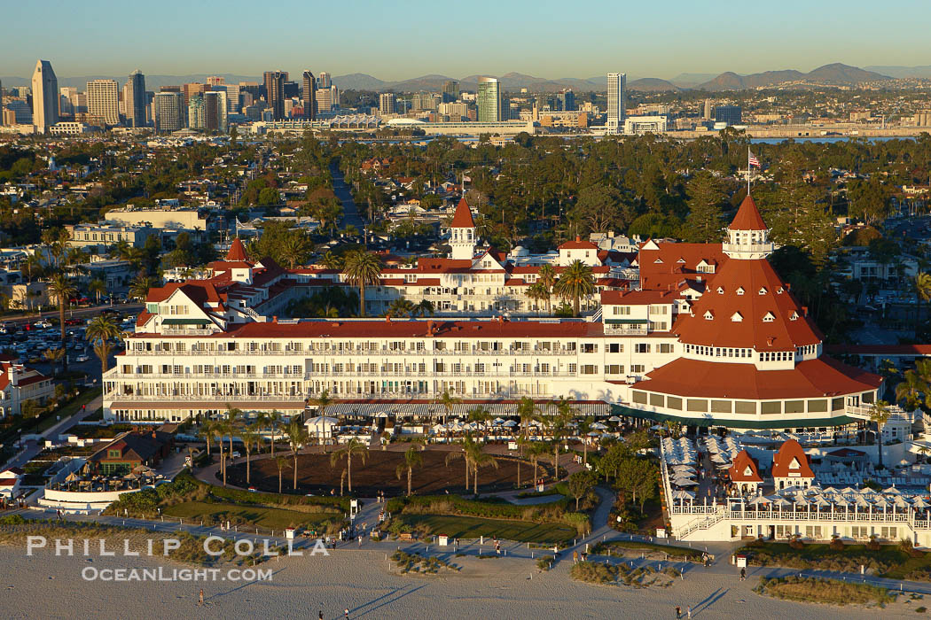 Hotel del Coronado, known affectionately as the Hotel Del.  It was once the largest hotel in the world, and is one of the few remaining wooden Victorian beach resorts.  It sits on the beach on Coronado Island, seen here with downtown San Diego in the distance.  It is widely considered to be one of Americas most beautiful and classic hotels. Built in 1888, it was designated a National Historic Landmark in 1977., natural history stock photograph, photo id 22296