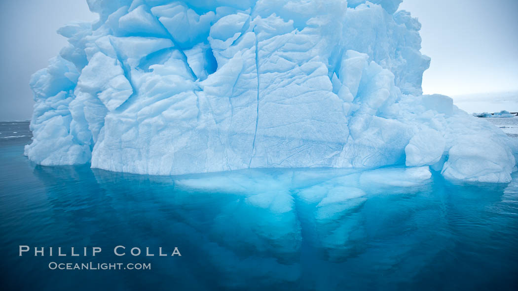 Iceberg above water and some of the underwater portion seen as well. Brown Bluff, Antarctic Peninsula, Antarctica, natural history stock photograph, photo id 24802