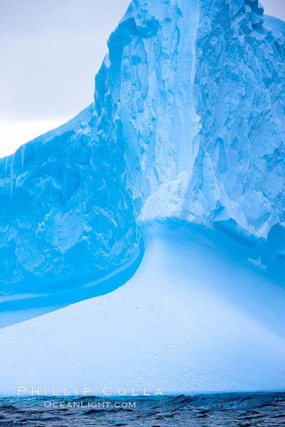 Iceberg, ocean, light and clouds.  Light plays over icebergs and the ocean near Coronation Island. South Orkney Islands, Southern Ocean, natural history stock photograph, photo id 24854