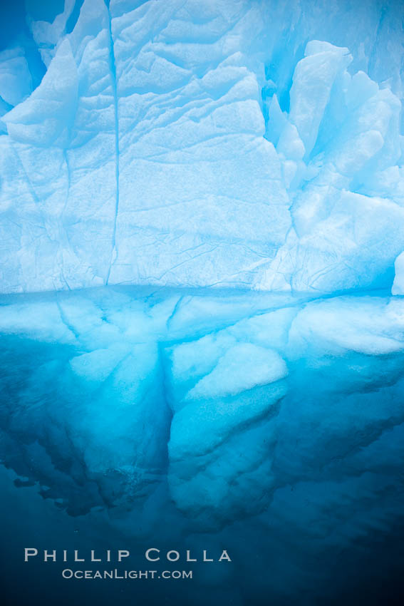 Iceberg above water and some of the underwater portion seen as well. Brown Bluff, Antarctic Peninsula, Antarctica, natural history stock photograph, photo id 24860