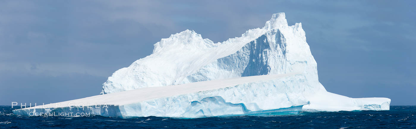 Iceberg panoramic photo.  Iceberg, ocean, light and clouds. Light plays over icebergs and the ocean near Coronation Island. South Orkney Islands, Southern Ocean, natural history stock photograph, photo id 26309