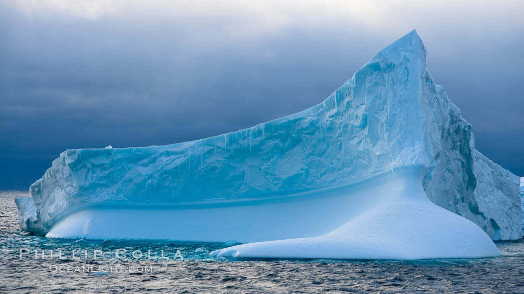 Iceberg, ocean, light and clouds.  Light plays over icebergs and the ocean near Coronation Island. South Orkney Islands, Southern Ocean, natural history stock photograph, photo id 24944