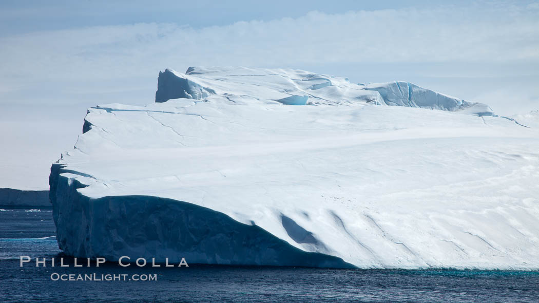 Iceberg and snow-covered coastline, Antarctic Sound. Antarctic Peninsula, Antarctica, natural history stock photograph, photo id 24811