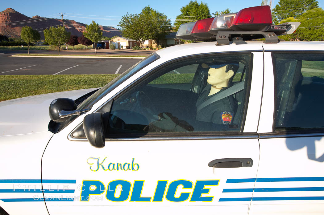 Inflatable cop.  Kanab's Finest, hard at work.  A Kanab police officer actively enforcing the speed limit in the town of Kanab, Utah. USA, natural history stock photograph, photo id 20767