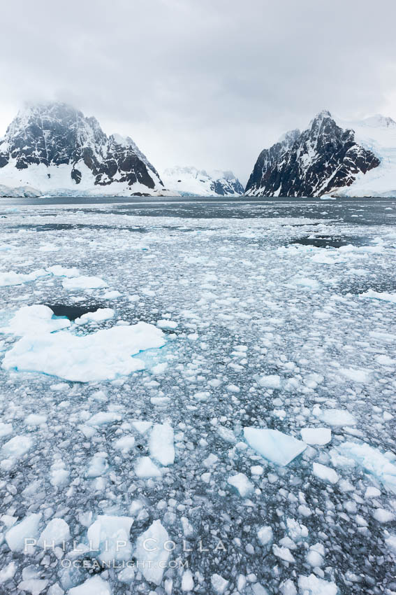 Lemaire Channel: mountains, sea, ice and clouds,Antarctica.  The Lemaire Channel, one of the most scenic places on the Antarctic Peninsula, is a straight 11 km long and only 1.6 km wide at its narrowest point., natural history stock photograph, photo id 25639