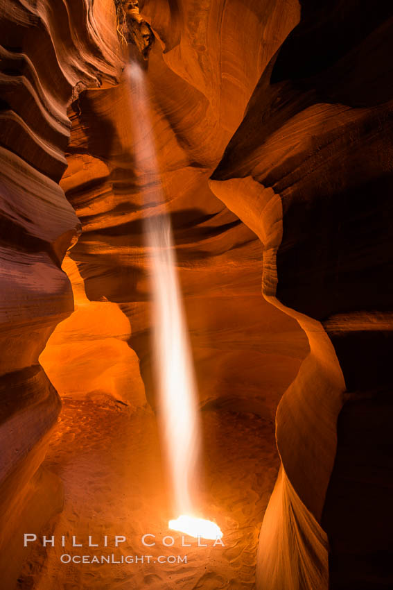 Light Beam in Upper Antelope Slot Canyon.  Thin shafts of light briefly penetrate the convoluted narrows of Upper Antelope Slot Canyon, sending piercing beams through the sandstone maze to the sand floor below. Navajo Tribal Lands, Page, Arizona, USA, natural history stock photograph, photo id 28572