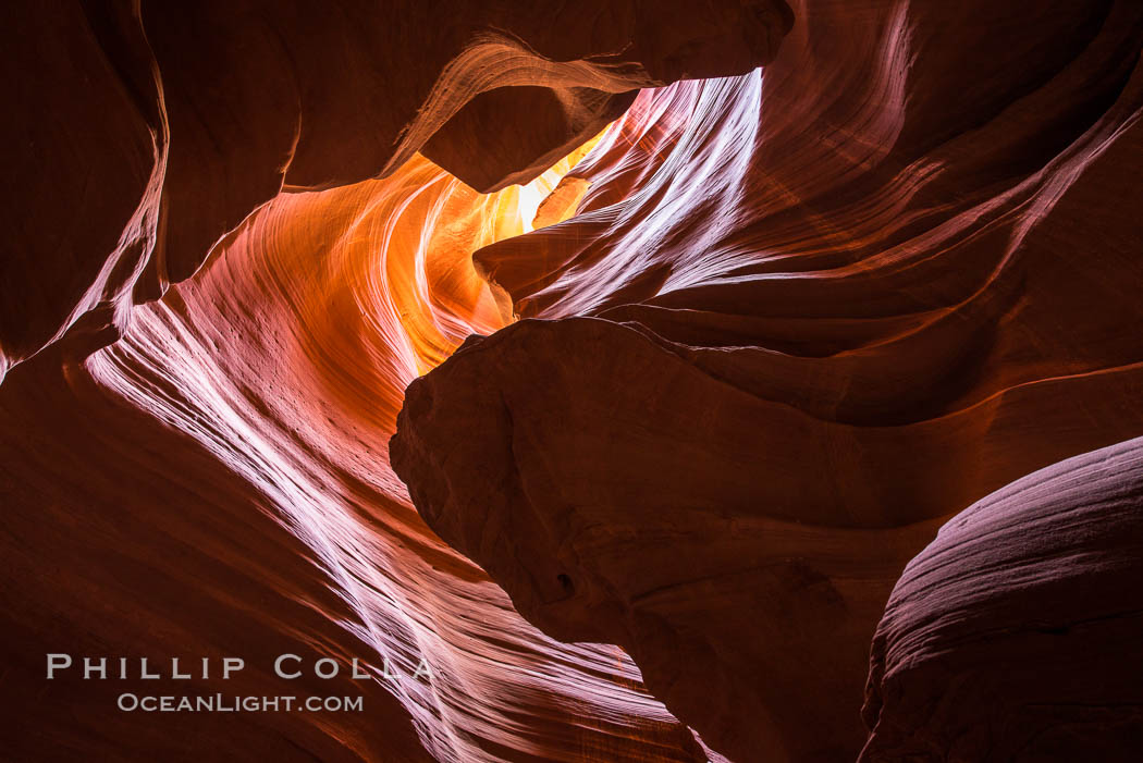 Light Beam in Upper Antelope Slot Canyon.  Thin shafts of light briefly penetrate the convoluted narrows of Upper Antelope Slot Canyon, sending piercing beams through the sandstone maze to the sand floor below. Navajo Tribal Lands, Page, Arizona, USA, natural history stock photograph, photo id 28567