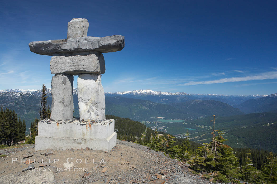 Ilanaaq, the logo of the 2010 Winter Olympics in Vancouver, is formed of stone in the Inukshuk-style of traditional Inuit sculpture.  Located near the Whistler mountain gondola station, overlooking Whistler Village and Green Lake in the distance. British Columbia, Canada, natural history stock photograph, photo id 21009